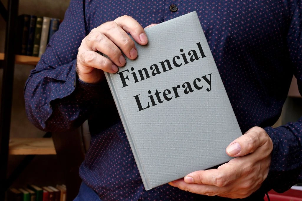 a man holding a financial literacy book