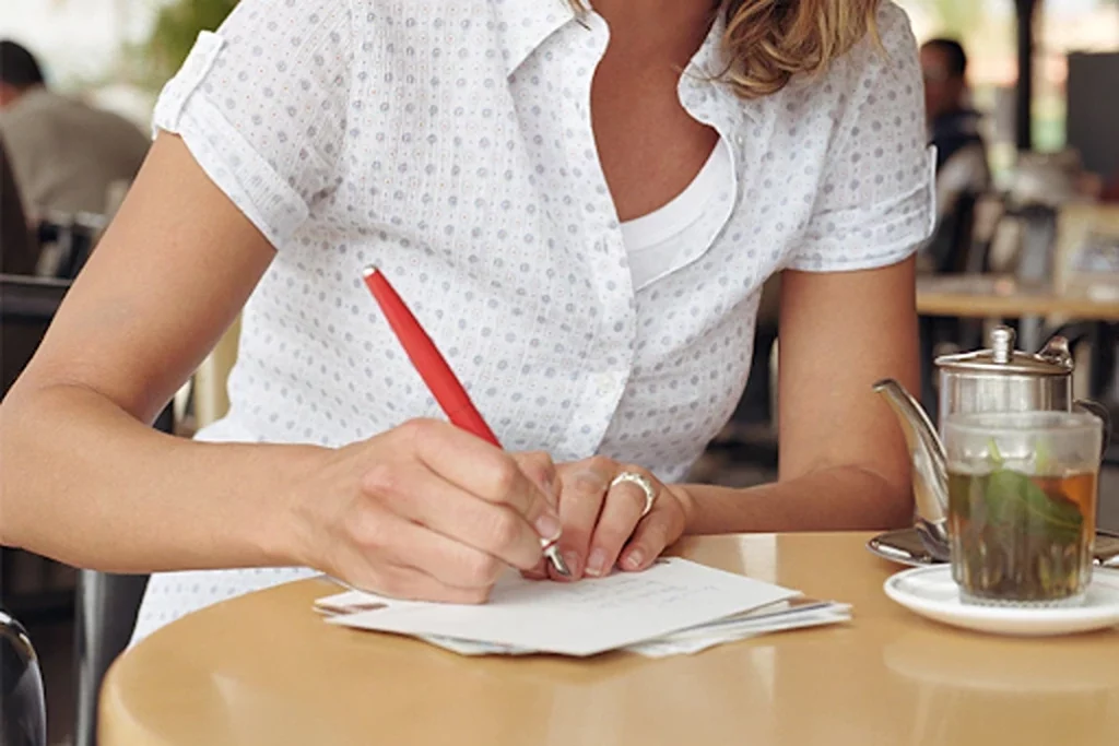 woman writing a note