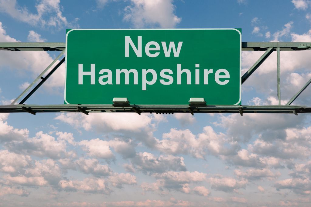 new hampshire on green road sign with sky background