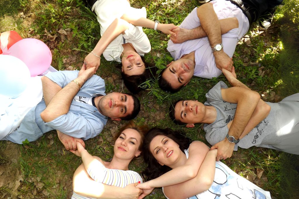 group of friends laying on the grass