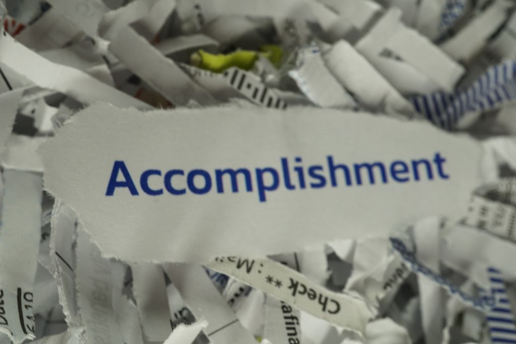 accomplishment text on shredded paper