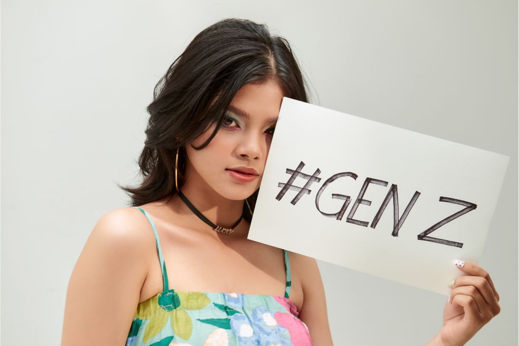 a teenager showing a text board with the text "gen z"