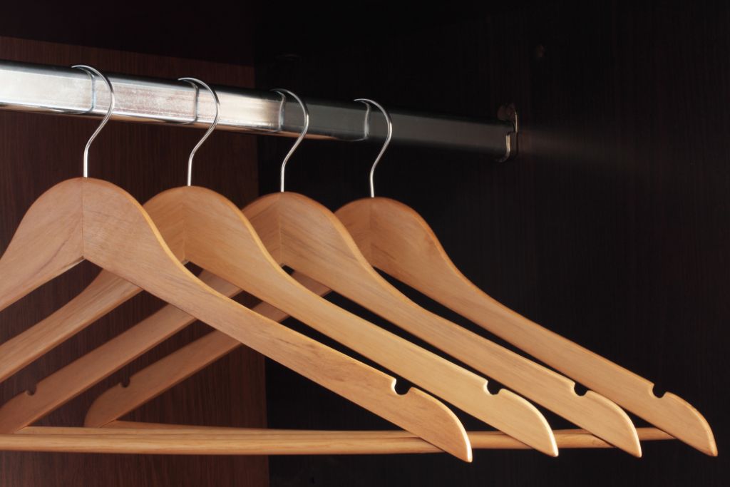 wooden hangers on clothes rail